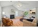 Open concept living space with kitchen view, fireplace, vaulted ceiling, and lots of light at 317 Cedarcroft Dr, Mooresville, NC 28115