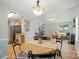 Open-concept living room and kitchen with hardwood floors, bright lighting, and modern appliances at 317 Cedarcroft Dr, Mooresville, NC 28115