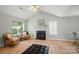 Bright living room featuring a fireplace, seating, and natural light at 317 Cedarcroft Dr, Mooresville, NC 28115