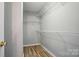 Spacious walk-in closet with shelving and wood-look floors at 317 Cedarcroft Dr, Mooresville, NC 28115