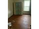 Bedroom featuring a standing mattress, window, and worn hardwood floors at 343 Dayvault Sw St, Concord, NC 28025