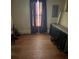 Simple bedroom featuring hardwood floors, dark curtains, and an electrical panel at 343 Dayvault Sw St, Concord, NC 28025