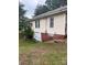 Exterior view of the home showing the vinyl siding, a window, and a brick foundation at 343 Dayvault Sw St, Concord, NC 28025