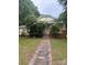 Quaint home featuring mature trees, yellow siding, and a charming covered front porch at 343 Dayvault Sw St, Concord, NC 28025