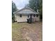 Rear of property shows exterior with a small deck and trashcans sitting outside at 343 Dayvault Sw St, Concord, NC 28025