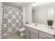 Well-lit bathroom with a gray vanity, modern fixtures, and a shower-tub combo with stylish shower curtain at 3436 Scottish Fern Ln # 172, Indian Land, SC 29707