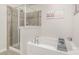 A bright bathroom featuring a soaking tub and a glass-enclosed shower at 3436 Scottish Fern Ln # 172, Indian Land, SC 29707