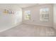 Bedroom featuring two windows, carpet flooring, and a blank canvas for personalized decor, ideal for restful nights at 3436 Scottish Fern Ln # 172, Indian Land, SC 29707