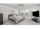 Bright bedroom with a ceiling fan, three large windows, and a comfy bed with decorative pillows and artwork at 3436 Scottish Fern Ln # 172, Indian Land, SC 29707