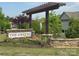Community entrance sign with stone base and pergola with landscaping in a well maintained residential area at 3436 Scottish Fern Ln # 172, Indian Land, SC 29707