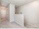 Hallway with carpet flooring and access to stairs, neutral paint, and multiple doors to other rooms at 3436 Scottish Fern Ln # 172, Indian Land, SC 29707