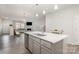 Open concept kitchen with a large island, stainless steel appliances, and seamless flow to living spaces at 3436 Scottish Fern Ln # 172, Indian Land, SC 29707