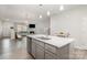 Kitchen island with white countertops, gray cabinets, and a view of the living area at 3436 Scottish Fern Ln # 172, Indian Land, SC 29707