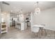 Contemporary kitchen features stainless steel appliances, gray cabinets, island with breakfast bar, and stylish pendant lighting at 3436 Scottish Fern Ln # 172, Indian Land, SC 29707