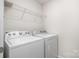 Practical laundry room featuring a washer, dryer, and wire shelving for organized storage at 3436 Scottish Fern Ln # 172, Indian Land, SC 29707