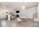 Open-concept living room featuring a fireplace, stylish seating, and abundant natural light, creating a bright and inviting space at 3436 Scottish Fern Ln # 172, Indian Land, SC 29707
