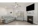 Comfortable living room with a fireplace, two sofas, large windows, and a ceiling fan at 3436 Scottish Fern Ln # 172, Indian Land, SC 29707