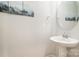 Modern powder room features a pedestal sink and decorative mirror at 3436 Scottish Fern Ln # 172, Indian Land, SC 29707