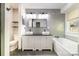Stylish bathroom with double sinks, a soaking tub, and modern gray tiling at 3505 Frostmoor Pl, Charlotte, NC 28269