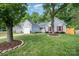 Charming single-Gathering home featuring a one car garage, red shutters and door, and a well-manicured lawn at 3505 Frostmoor Pl, Charlotte, NC 28269