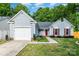Charming single-Gathering home featuring a one car garage, red shutters and door, and a well-manicured lawn at 3505 Frostmoor Pl, Charlotte, NC 28269