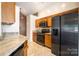 Modern kitchen featuring stainless steel appliances, granite countertops and tile floors at 3505 Frostmoor Pl, Charlotte, NC 28269