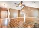 Open-concept living room with hardwood floors, ceiling fan, and lots of natural light at 3505 Frostmoor Pl, Charlotte, NC 28269