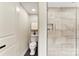 Half bathroom with a sleek toilet and a view of the adjacent walk-in shower at 3661 Annlin Ave, Charlotte, NC 28209