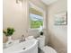Bathroom featuring modern sink, toilet, decor, and a window for natural light at 3661 Annlin Ave, Charlotte, NC 28209