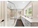 Luxurious bathroom with a frameless shower, double vanity, and elegant fixtures at 3661 Annlin Ave, Charlotte, NC 28209