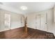 Bedroom featuring hardwood floors, neutral walls, and closet and bathroom access at 3661 Annlin Ave, Charlotte, NC 28209