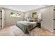 Cozy bedroom with neutral tones, two windows, and hardwood floors at 3661 Annlin Ave, Charlotte, NC 28209