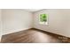 Bedroom with hardwood floors, a window and fresh paint at 3661 Annlin Ave, Charlotte, NC 28209