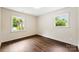 Bedroom featuring hardwood floors, neutral walls, and two windows for natural light at 3661 Annlin Ave, Charlotte, NC 28209