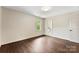 Bedroom featuring hardwood floors and a view of the bathroom at 3661 Annlin Ave, Charlotte, NC 28209