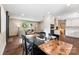 Open dining area with a wooden table and chairs, adjacent to a cozy living space and modern kitchen at 3661 Annlin Ave, Charlotte, NC 28209