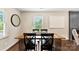 Dining room with a rustic wooden table, modern chairs, and natural light at 3661 Annlin Ave, Charlotte, NC 28209