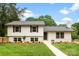 Charming two-story home featuring a manicured lawn, fresh landscaping, and a classic white facade at 3661 Annlin Ave, Charlotte, NC 28209