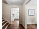 Hallway view leading to a modern kitchen with white cabinets and stainless steel appliances at 3661 Annlin Ave, Charlotte, NC 28209