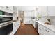 Modern kitchen featuring white cabinets, stainless steel appliances, and stylish backsplash at 3661 Annlin Ave, Charlotte, NC 28209
