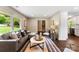 Well-lit living space with hardwood floors, connecting to the kitchen and stairway at 3661 Annlin Ave, Charlotte, NC 28209