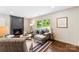 Comfortable living room with a dark fireplace, hardwood floors, and a bright window at 3661 Annlin Ave, Charlotte, NC 28209