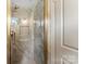 Modern shower with gray tiling, glass door, and rainfall shower head fixture at 3661 Annlin Ave, Charlotte, NC 28209