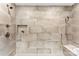 Modern shower with beige tiling, sleek fixtures, built-in niche, and seating at 3661 Annlin Ave, Charlotte, NC 28209