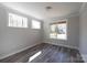 Bright bedroom features three windows and modern gray floors at 4531 Dry Run Rd, Fort Mill, SC 29708