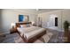 Bedroom features an archway into the bathroom, wooden floors and a light colored rug at 4531 Dry Run Rd, Fort Mill, SC 29708