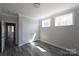 Bright bedroom features two windows, modern gray floors, white trim, and a spacious closet at 4531 Dry Run Rd, Fort Mill, SC 29708