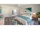 Bright bedroom features a white bed, teal accents, and a connecting bathroom with a soaking tub at 4531 Dry Run Rd, Fort Mill, SC 29708