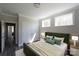 Comfortable bedroom with natural wood floors and trim, two windows, and view to hall at 4531 Dry Run Rd, Fort Mill, SC 29708