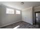 Bright bedroom features two windows, modern gray floors, white trim, and a spacious closet at 4531 Dry Run Rd, Fort Mill, SC 29708